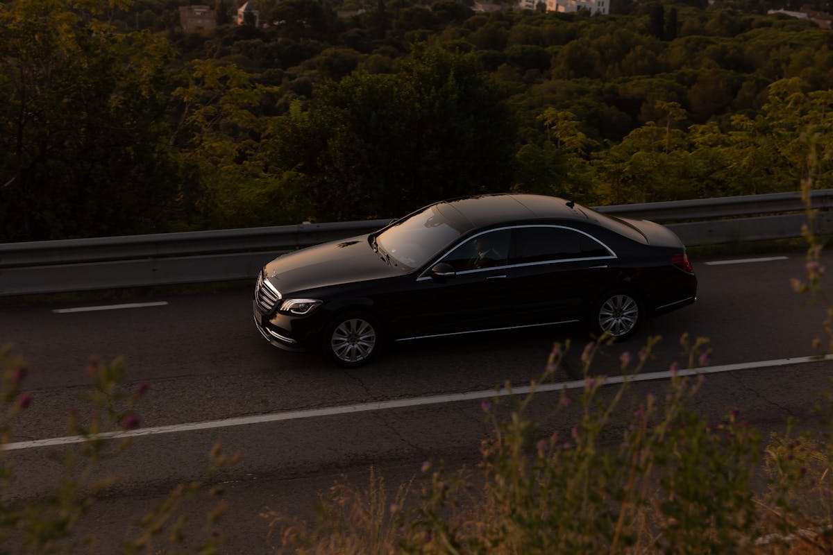 Premier Chauffeurs — black luxury sedan in transit